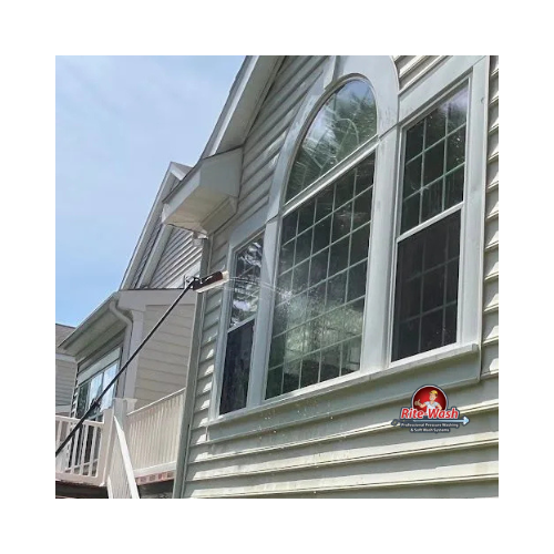 A ladder is attached to the roof of a house