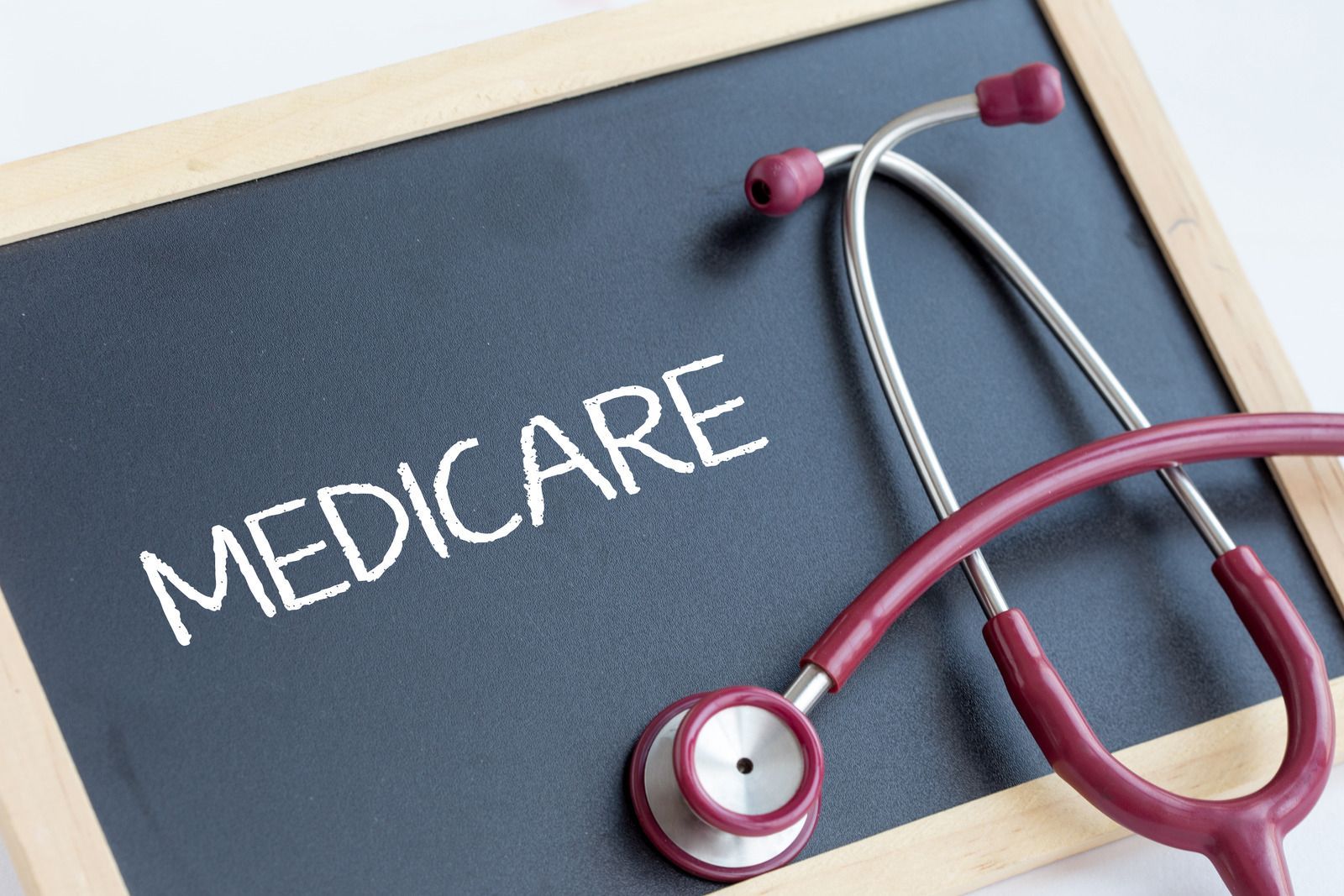 Medicare chalkboard with a red stethoscope on a wooden frame