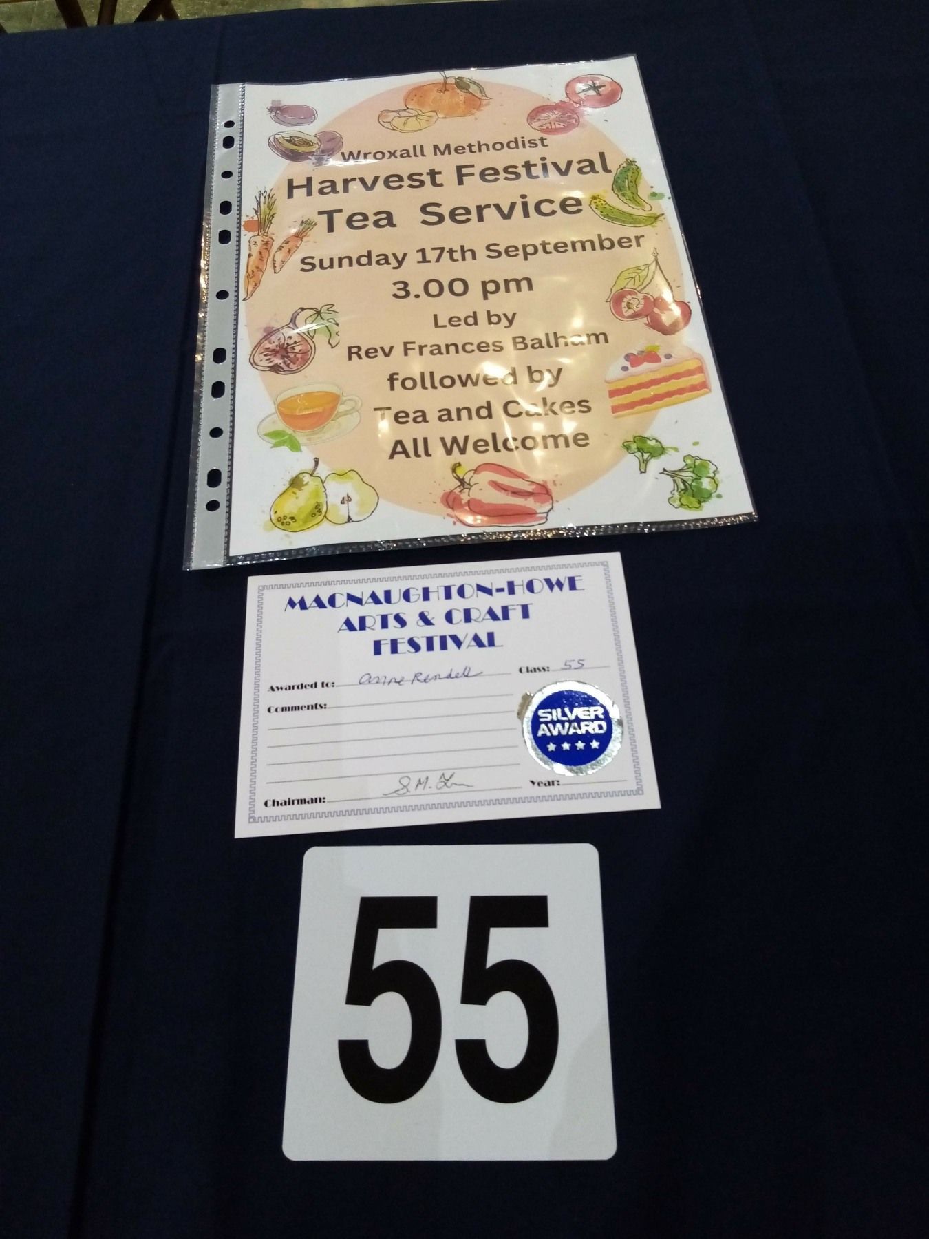 A sign for the harvest festival tea service sits on a table