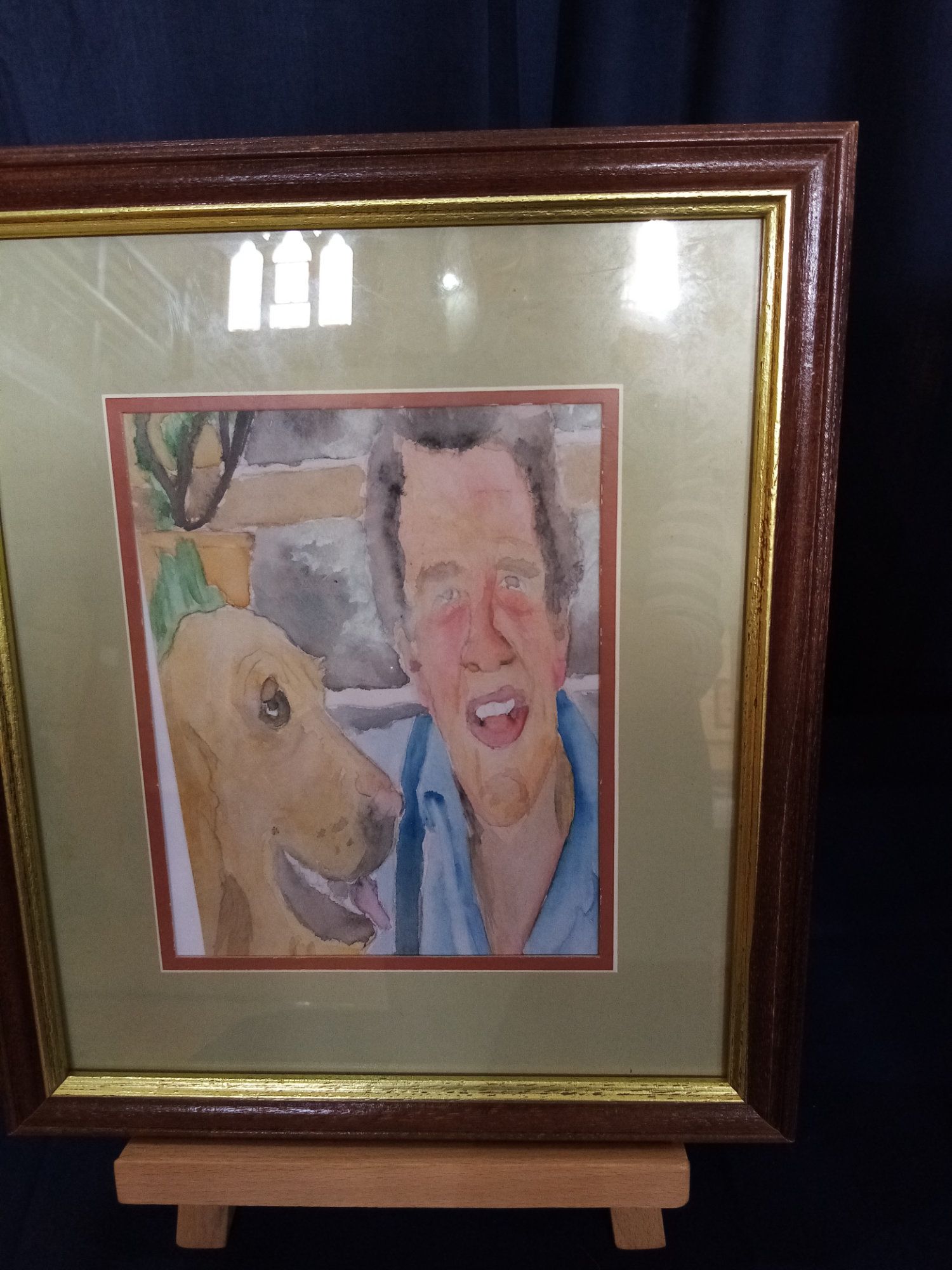 A framed picture of a man and his dog