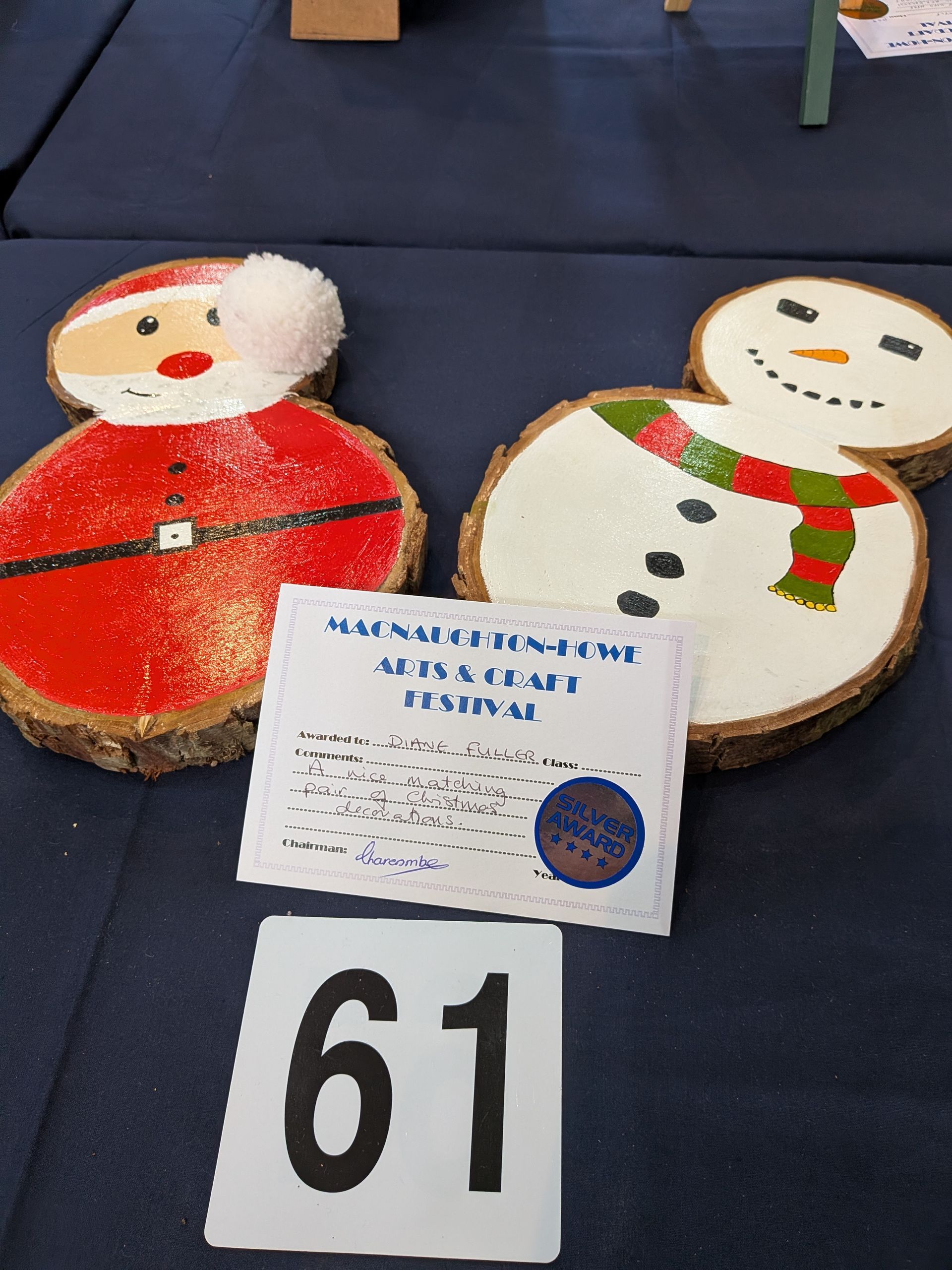Santa and snowman wood slice decorations, with festival card and number 61.