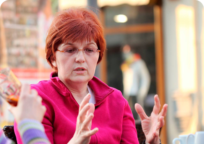 woman talking wearing pink jacket
