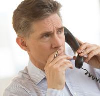 man holding pen and phone
