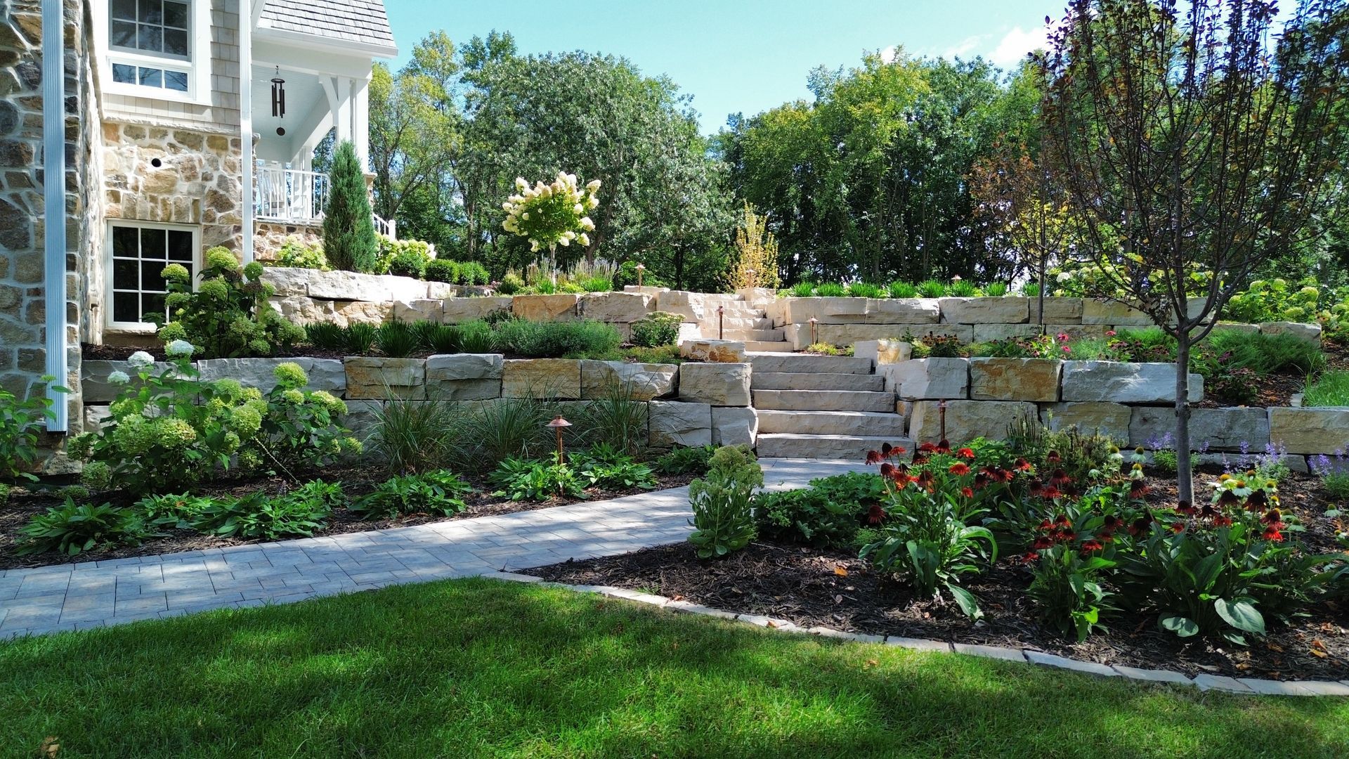 A row of concrete pillars surrounding a lush green lawn