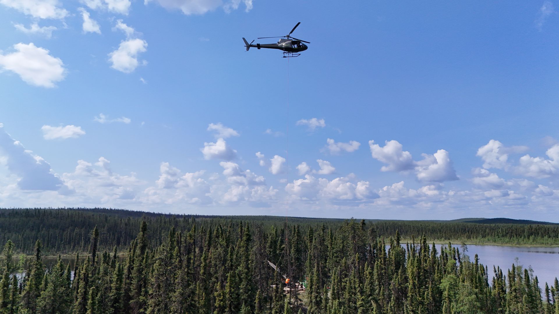 Helicopter over forests for Cosa Resources Saskatchewan uranium mining and exploration in Canada.