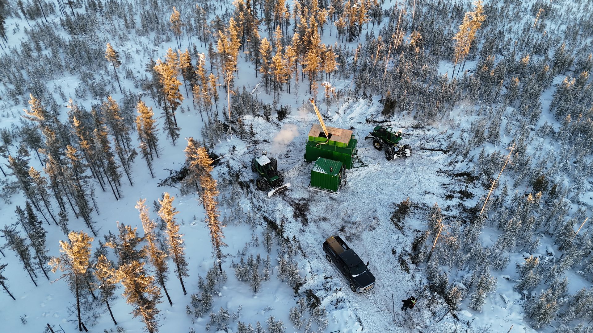 Aerial view of drill equipment in a snowy forest for Cosa Resources Saskatchewan uranium mining in Canada.