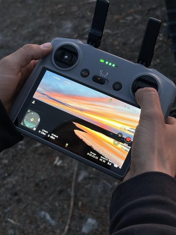 Drone operator surveying a sunset landscape for Cosa Resources Saskatchewan uranium mining in Canada.