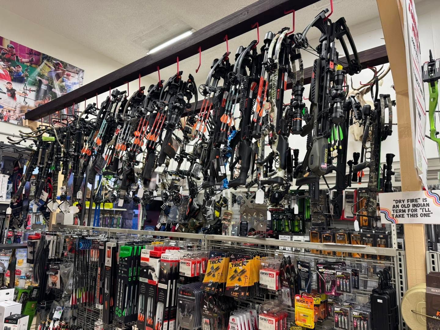Rows of arrows with red, yellow, green, and blue fletching standing in a rack