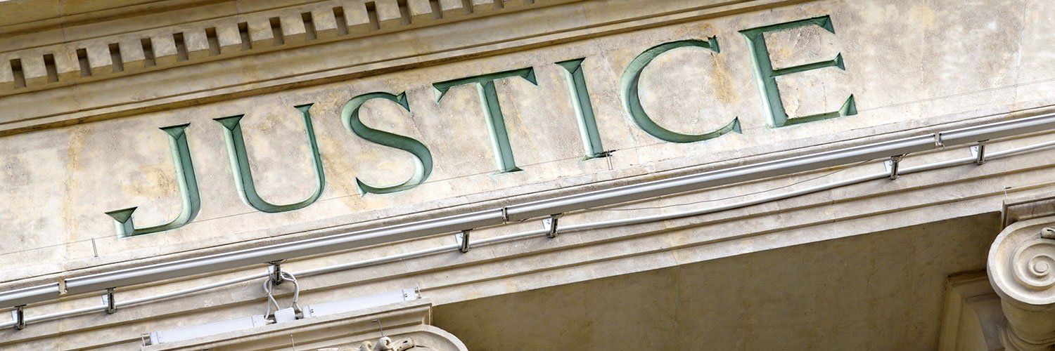 The word justice is written on the side of a building.