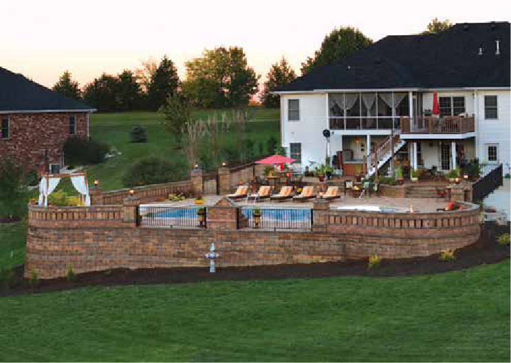 An Outdoor Landscape by Stockman Stoneworks Surrounding a Saltwater Pool.