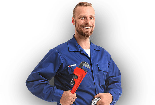 A man in a blue uniform is holding a wrench and smiling.