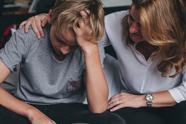 Troubled adolescent boy with mom