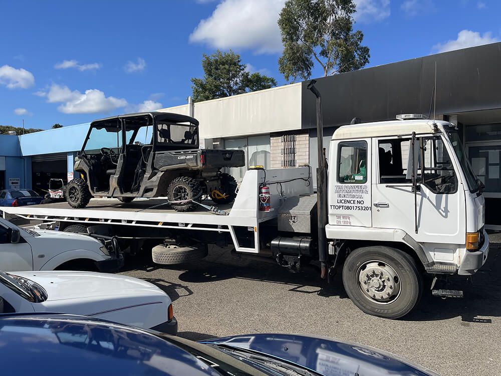Tow Truck With Utility Vehicle On The Back — Big Tim's Towing in Cessnock, NSW