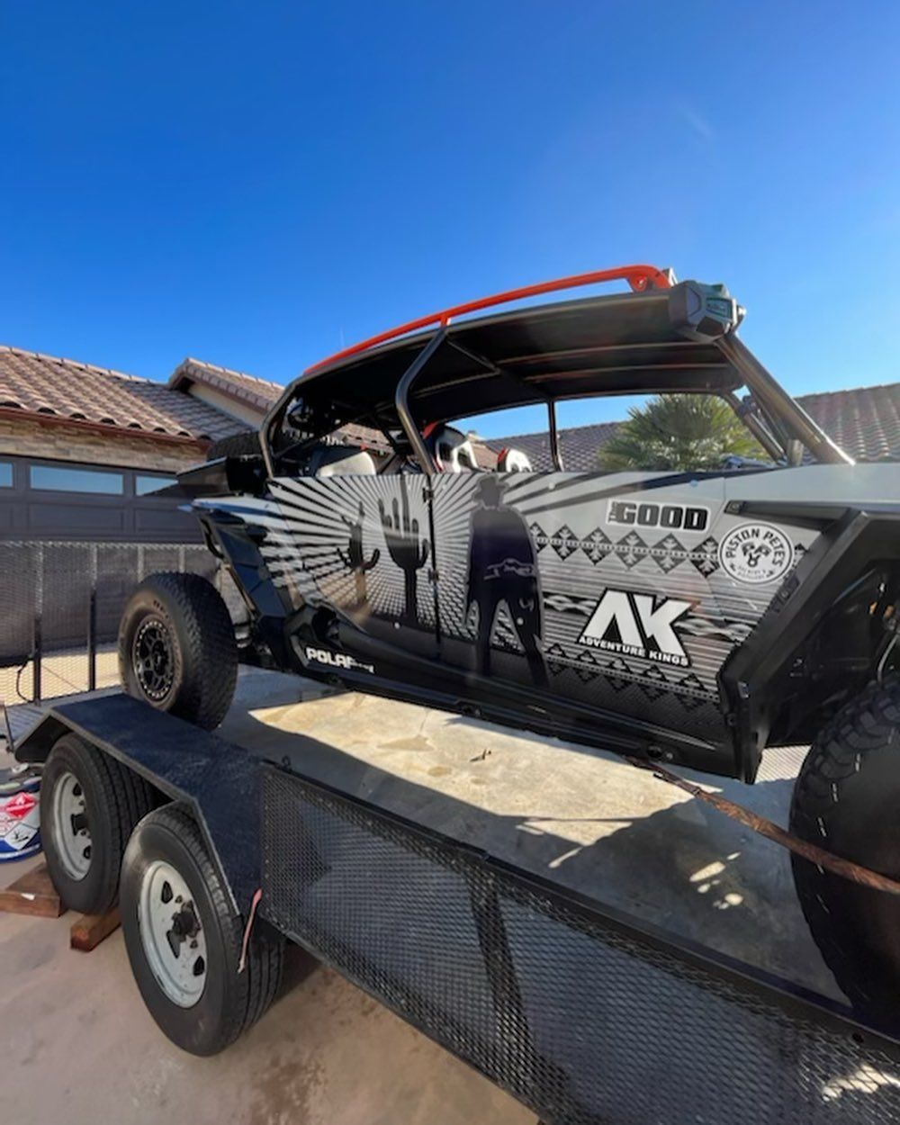 A atv is sitting on top of a trailer.