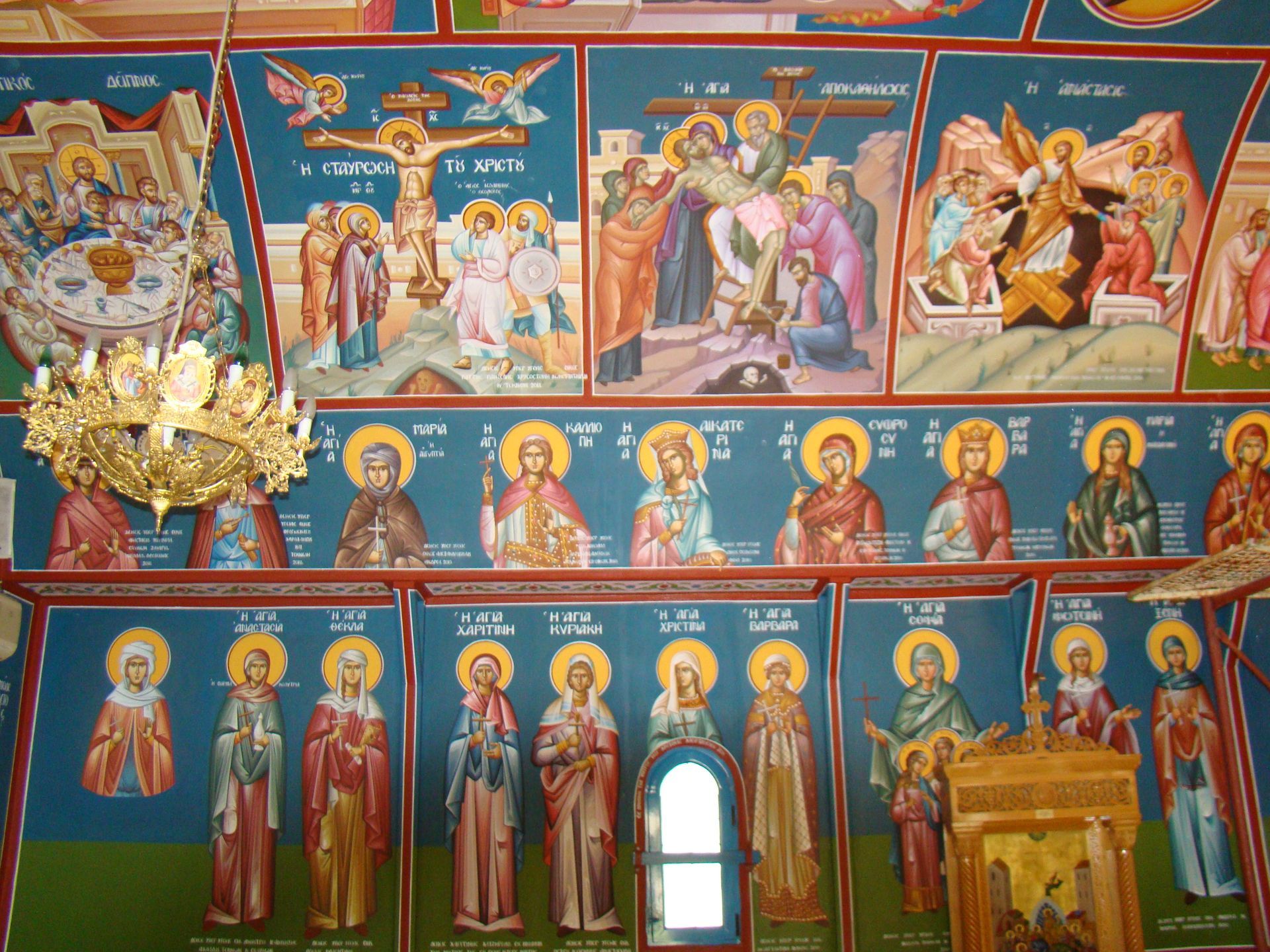 A row of paintings on a wall with one that says ' jesus ' on it