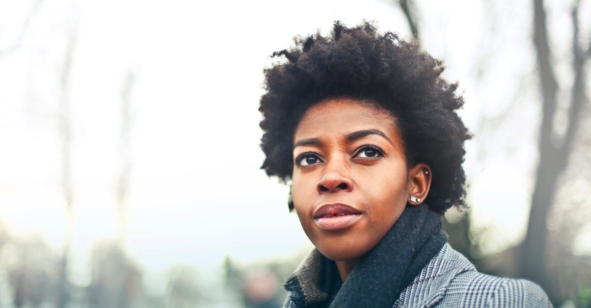 A close up of a woman wearing a scarf and a jacket.
