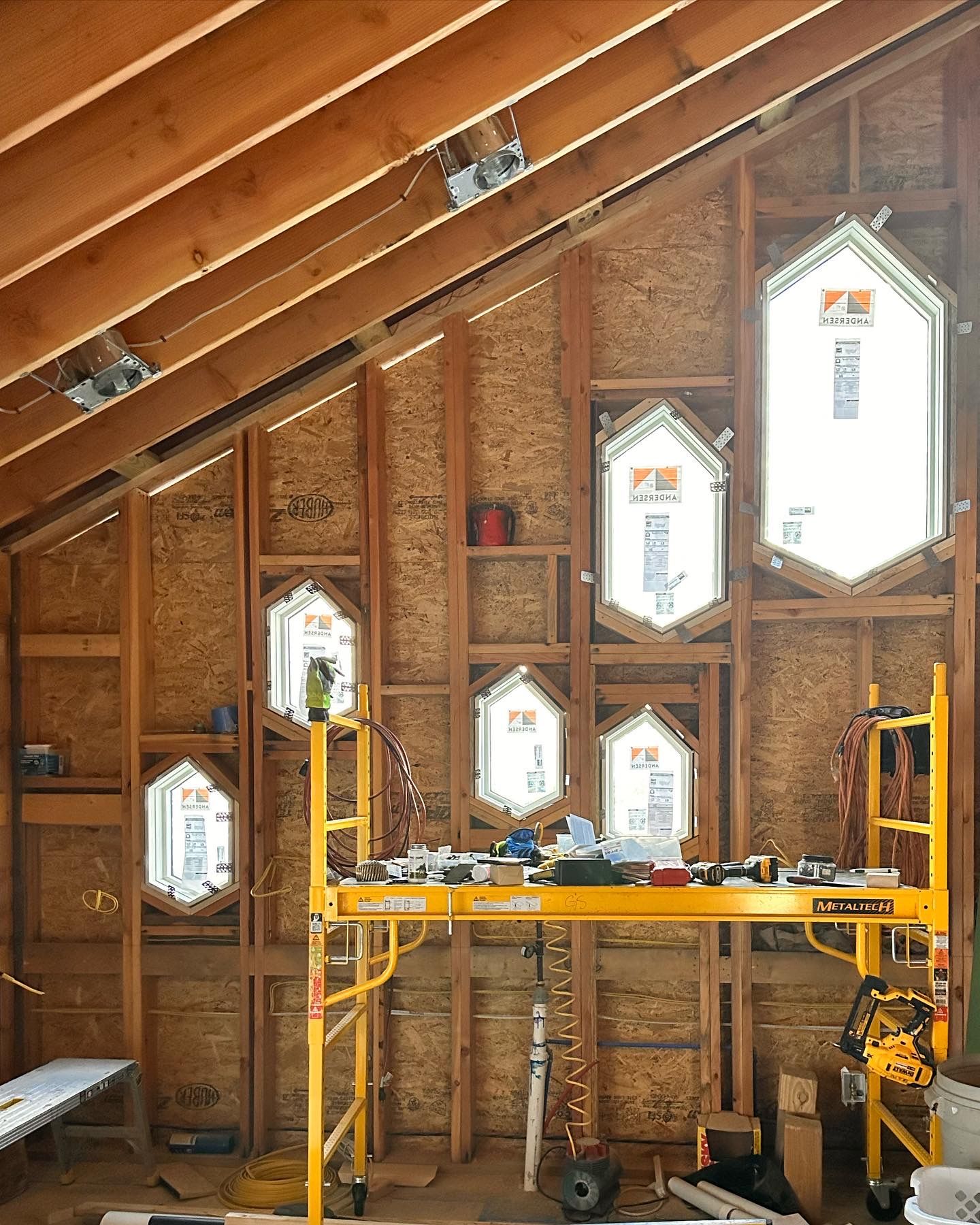 A building under construction with a yellow scaffolding in the middle