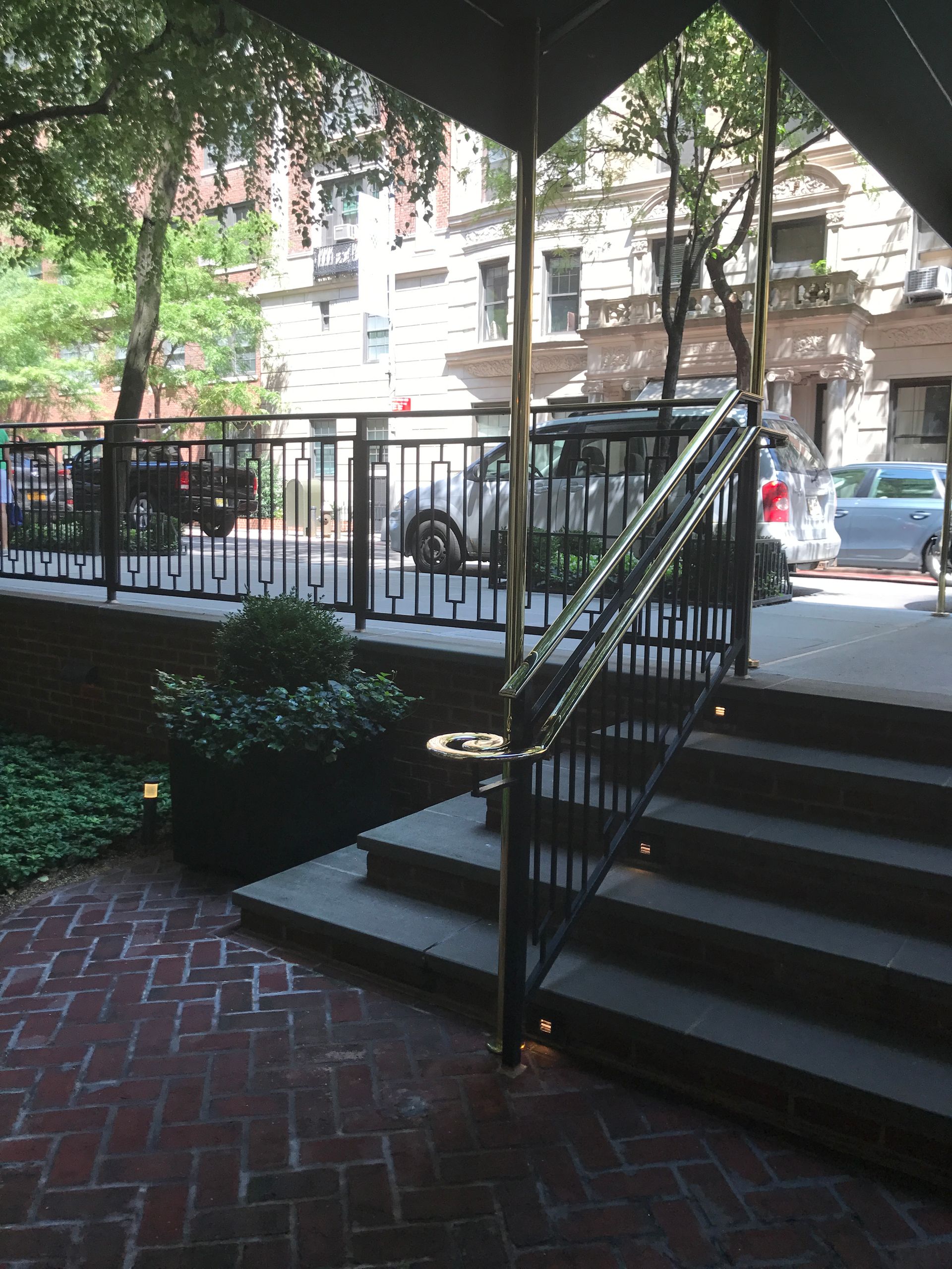 A brick walkway with stairs leading up to a building