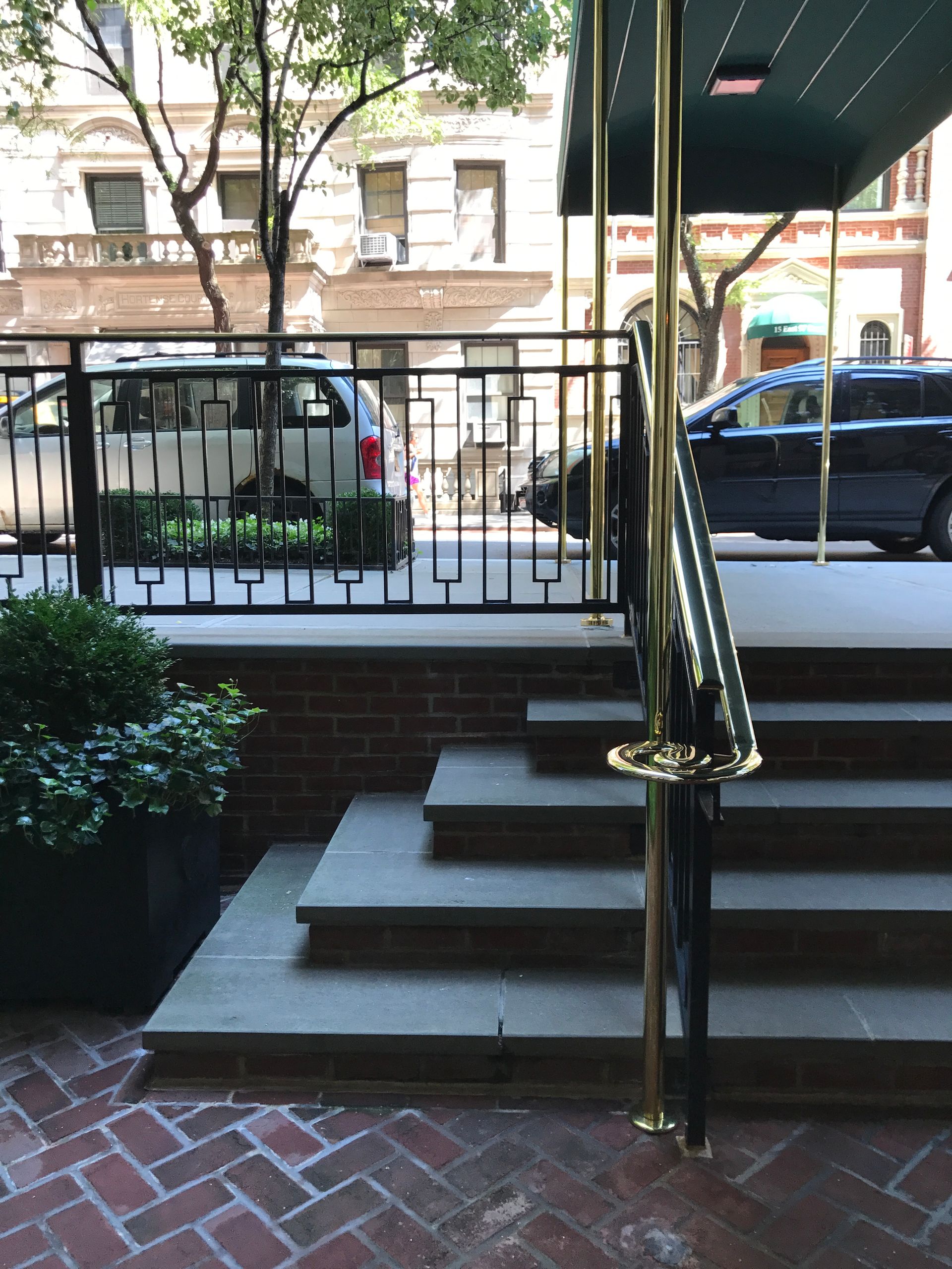 A black van is parked in front of a brick building