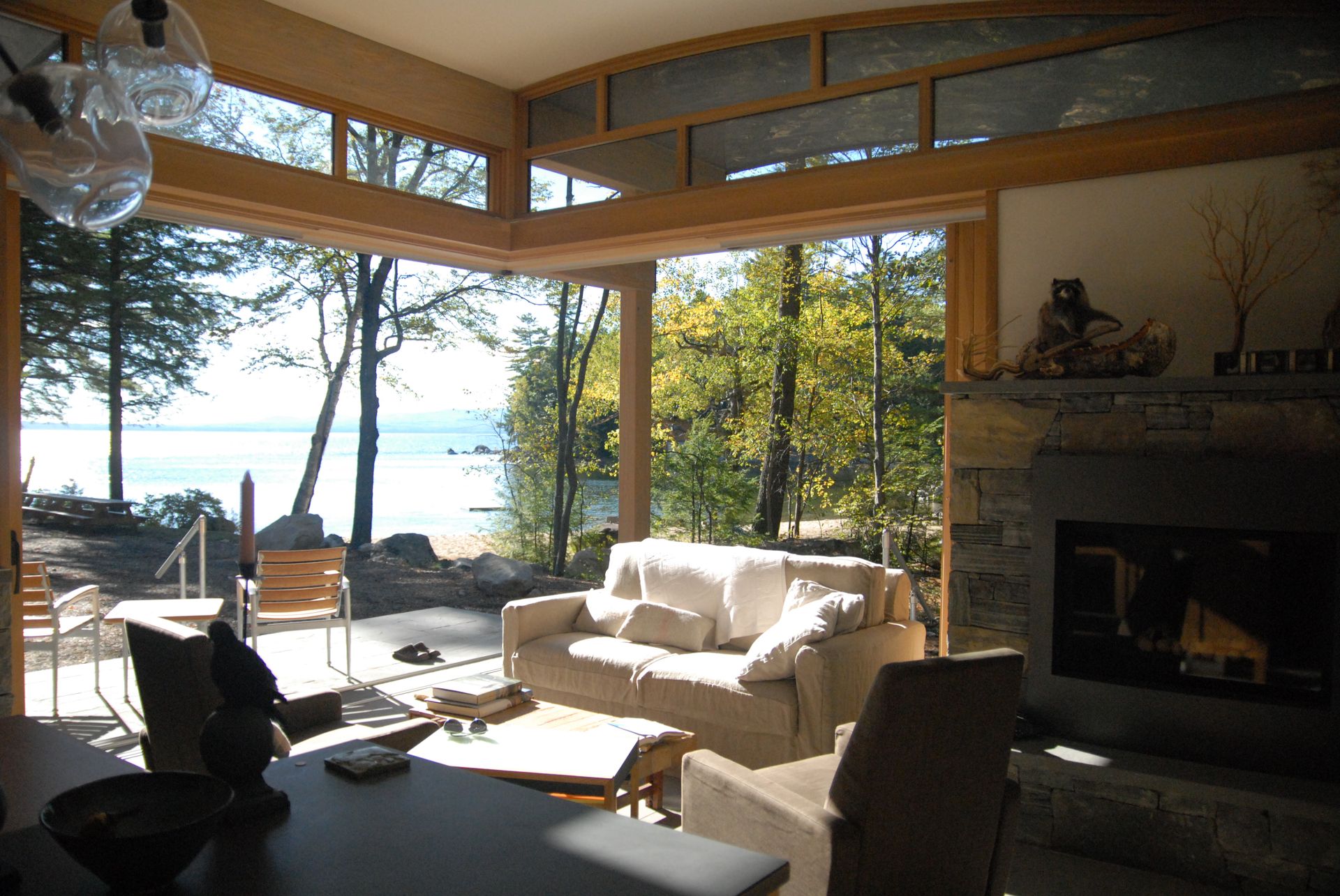 A living room with a fireplace and a view of the water