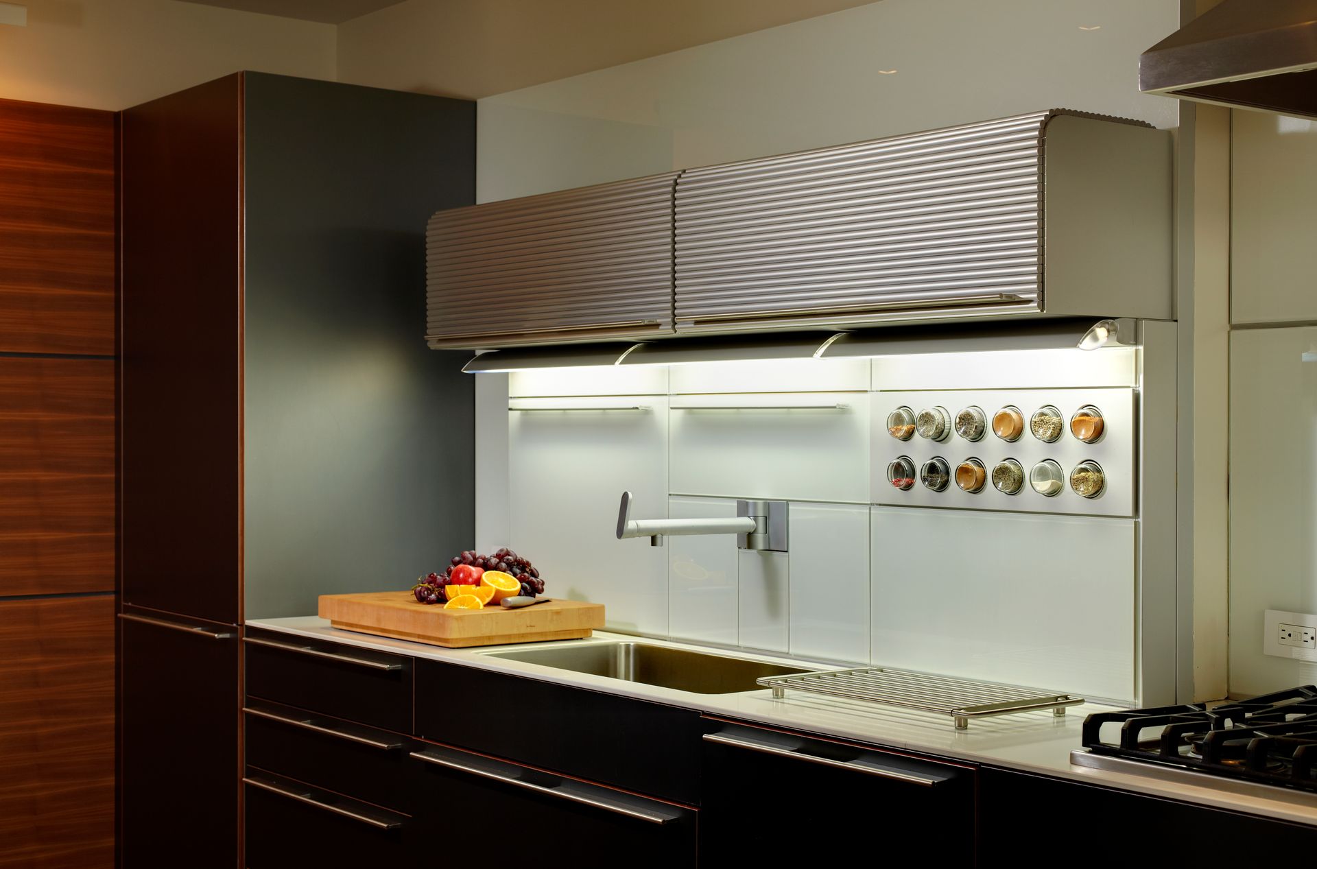 A kitchen with two sinks and a stove top oven