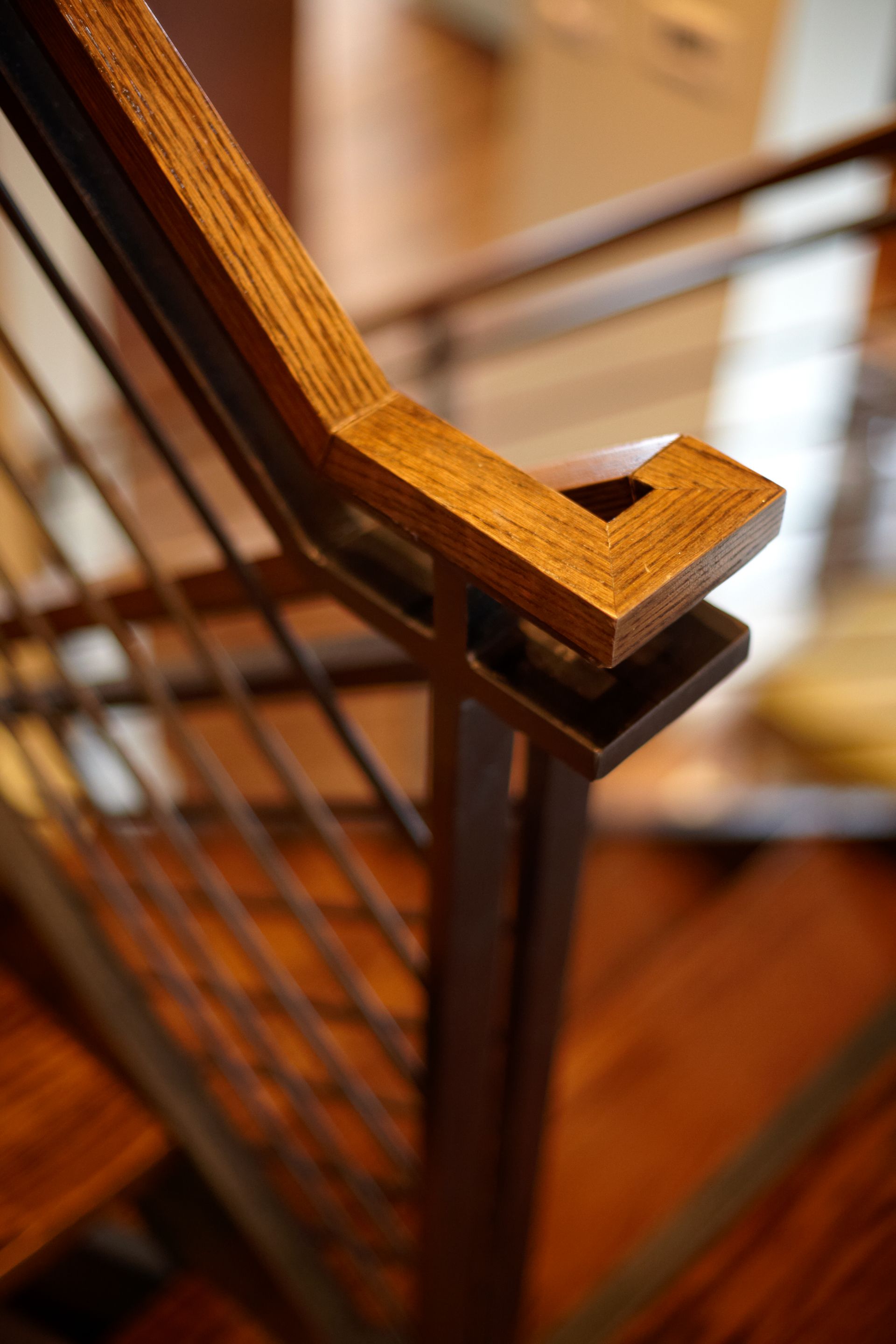 A close up of a wooden railing on a staircase.