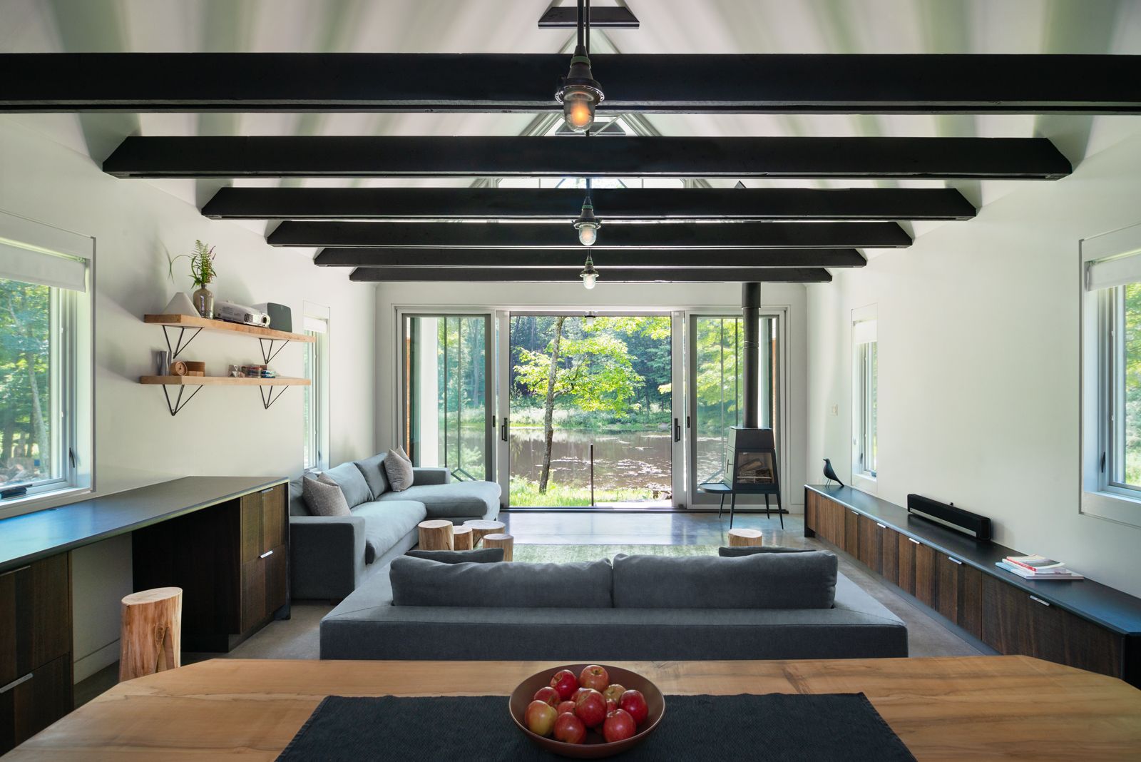 There is a bowl of apples on the table in the living room.