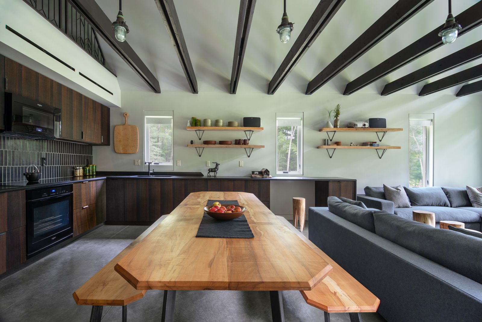 There is a large wooden table in the middle of the room.