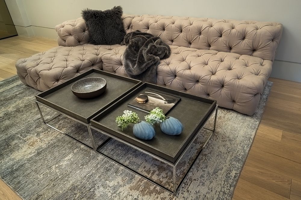 A living room with a couch and two coffee tables