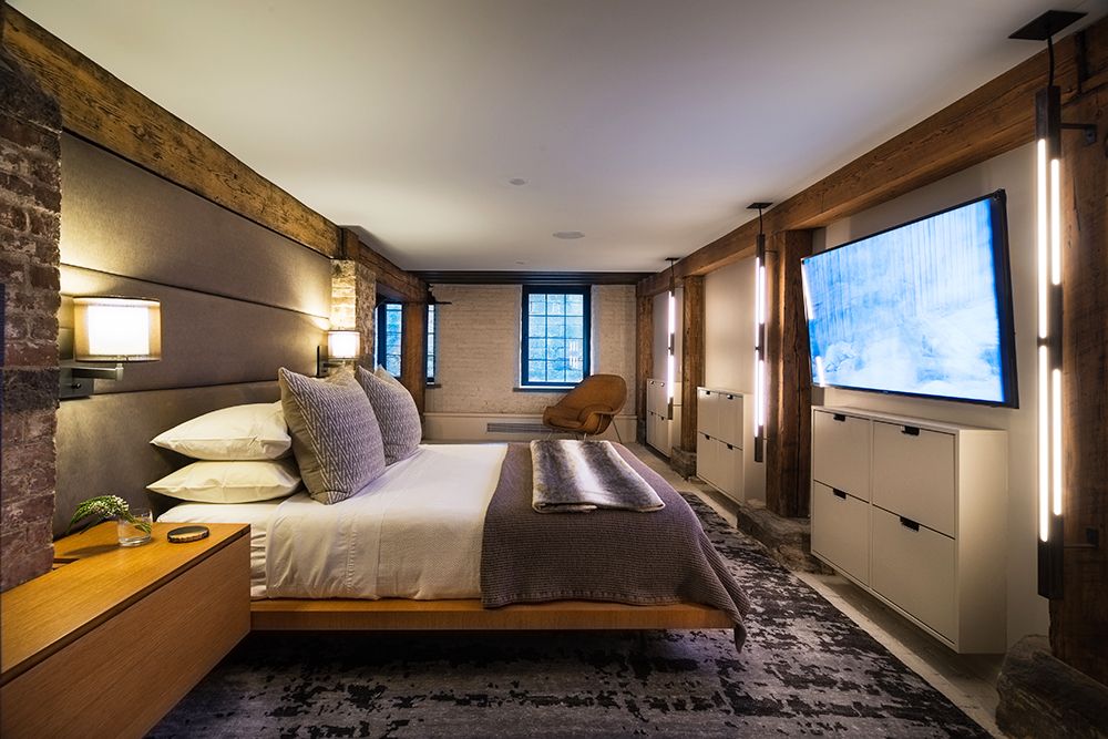 A hotel room with a large bed and a flat screen tv