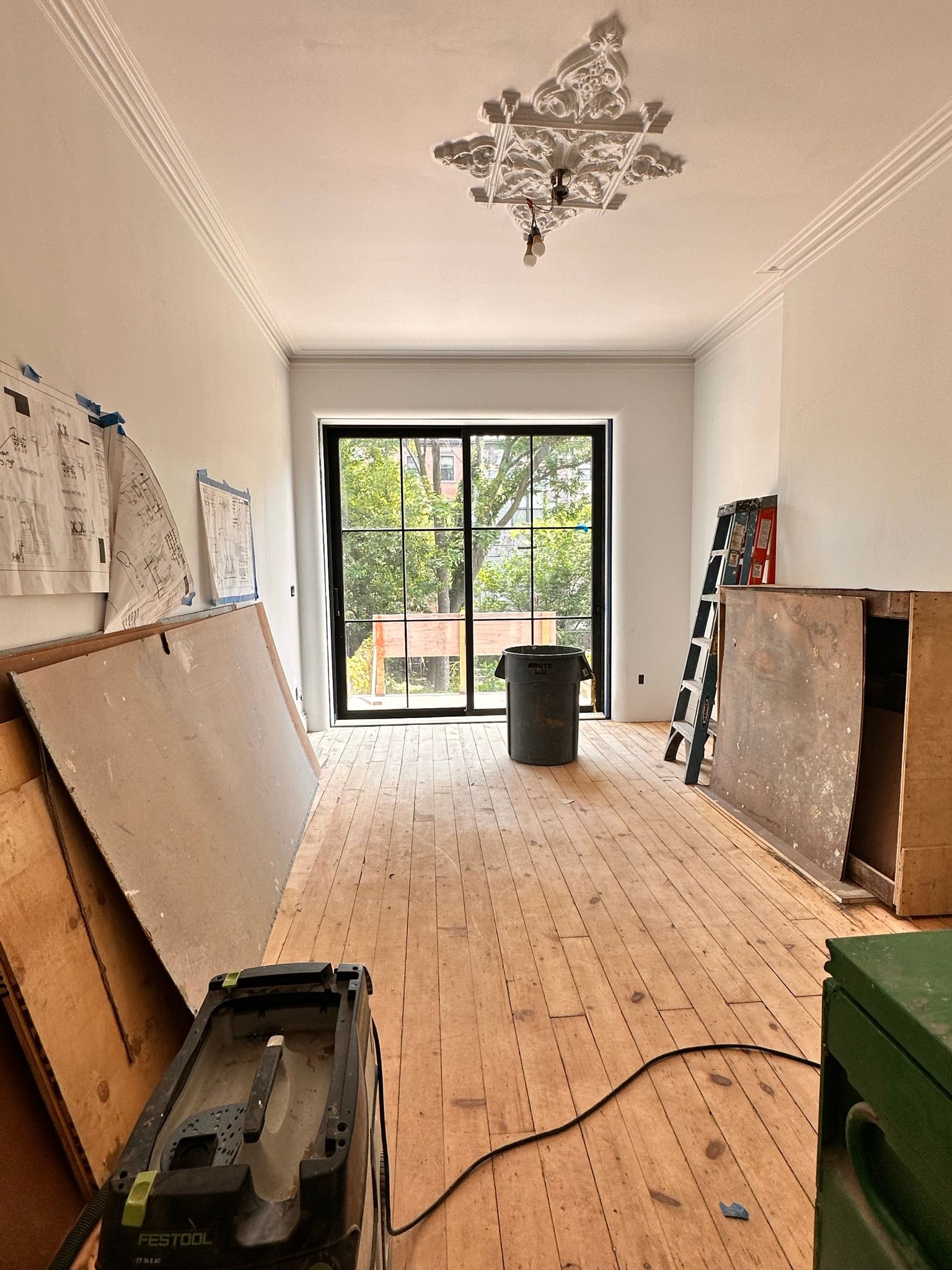A room with wooden floors and a sliding glass door