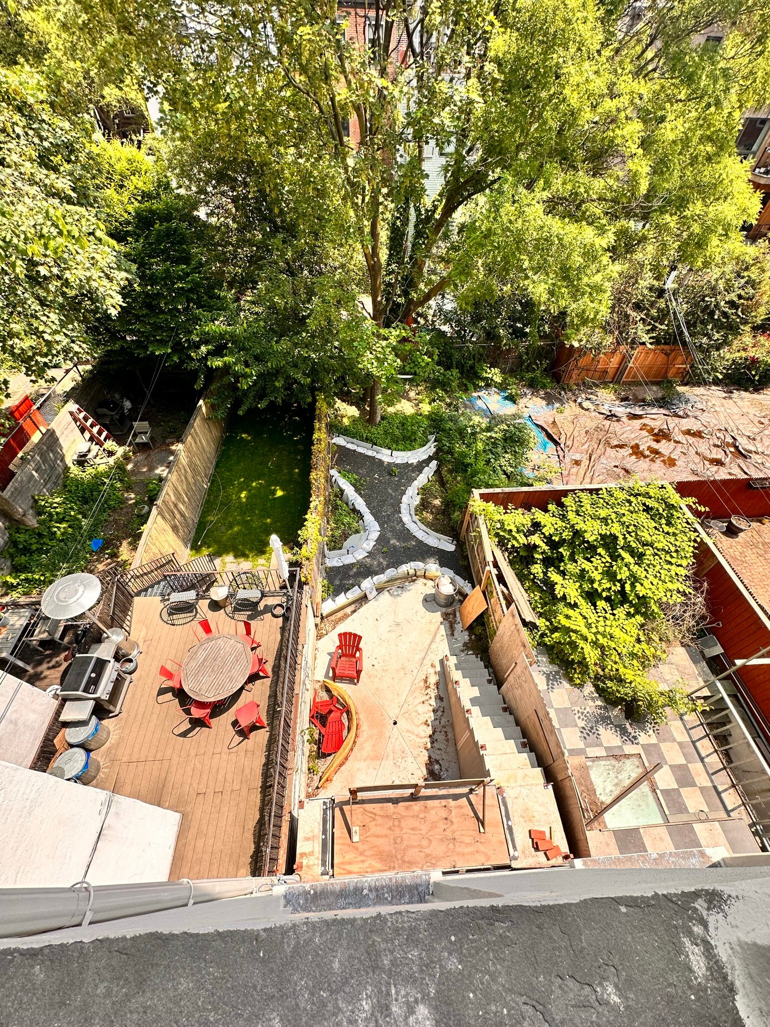An aerial view of a backyard with a pool and a table and chairs.