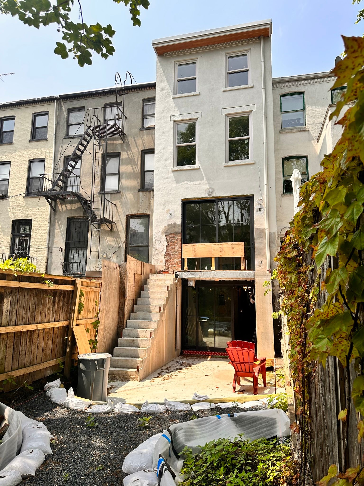 A white building with stairs leading up to it