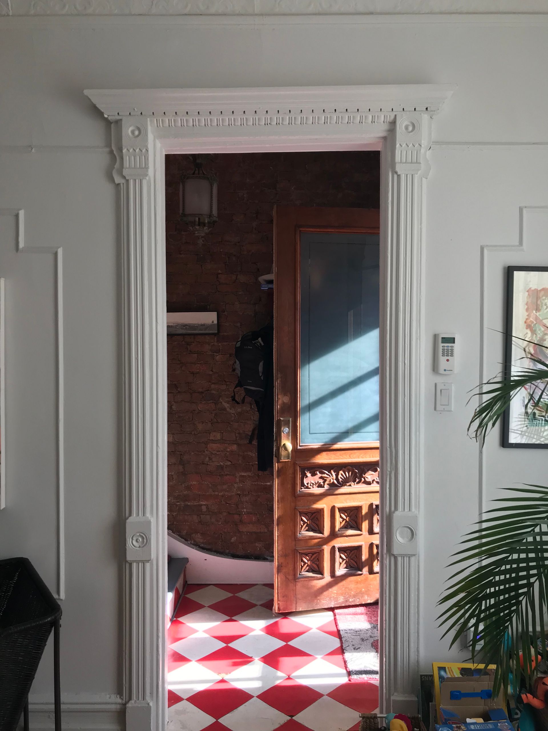 A doorway leading into a room with a checkered floor