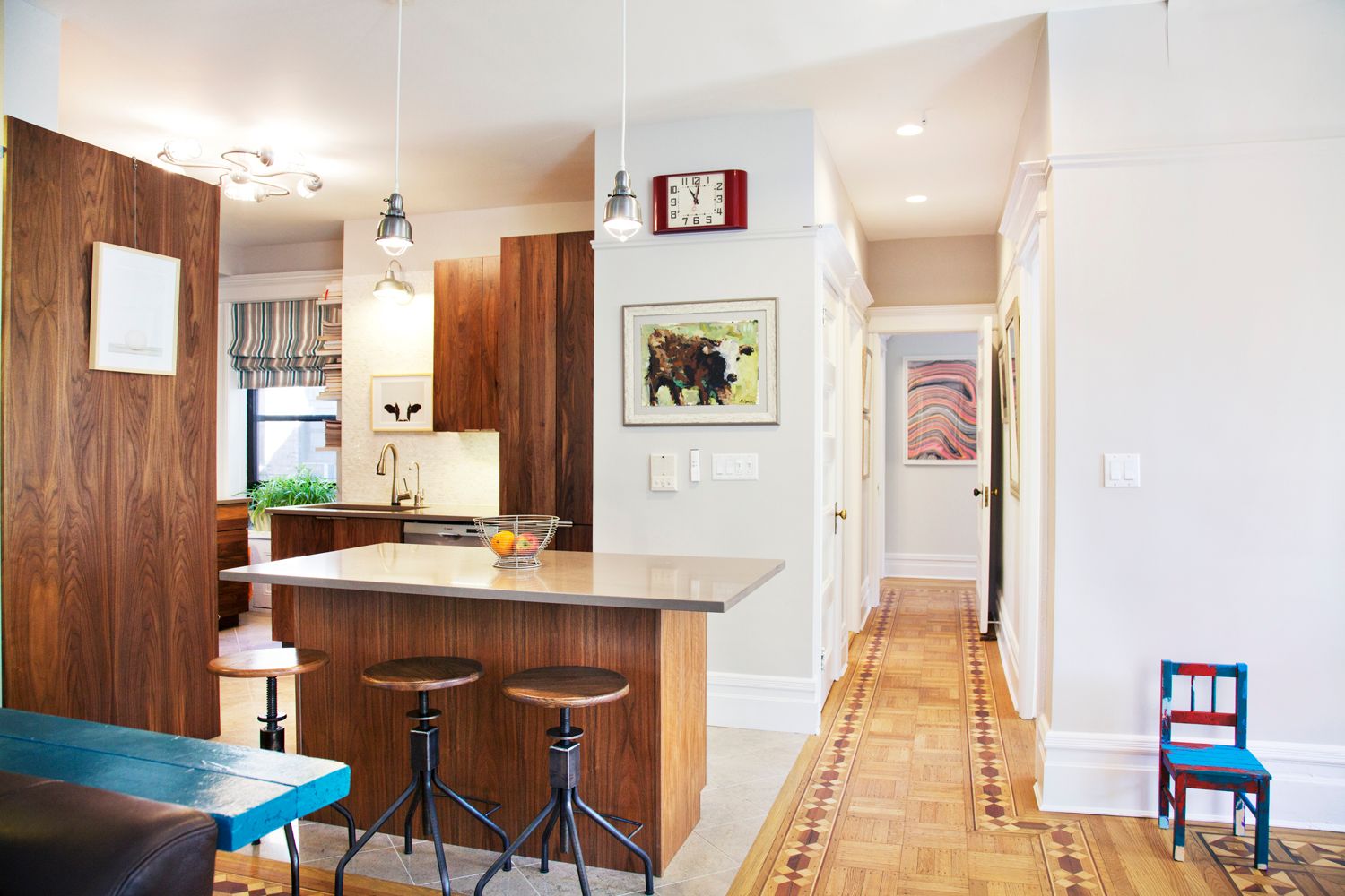 A kitchen with a large island and stools