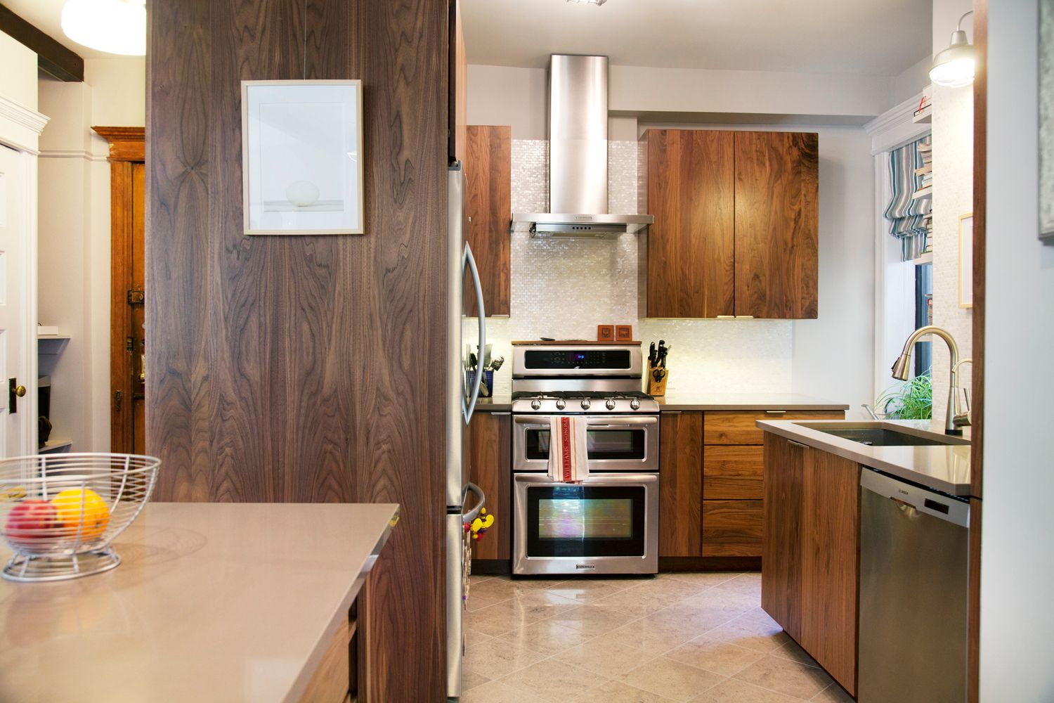 A kitchen with stainless steel appliances and wooden cabinets