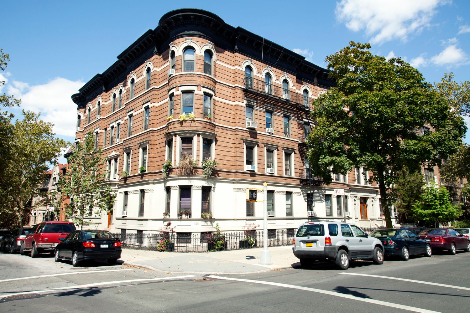 A brick building with cars parked in front of it