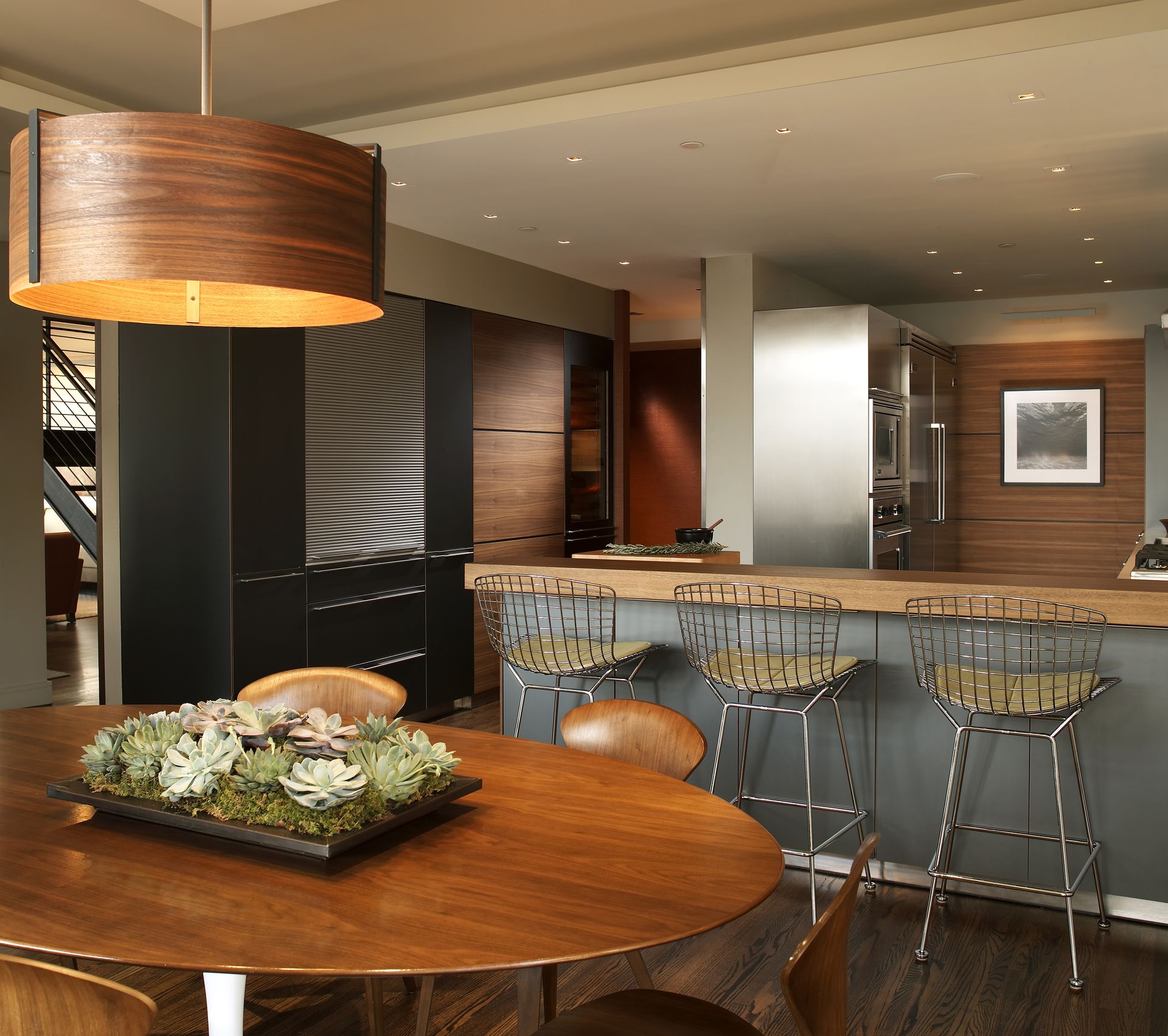 A dining room table with a tray of flowers on it