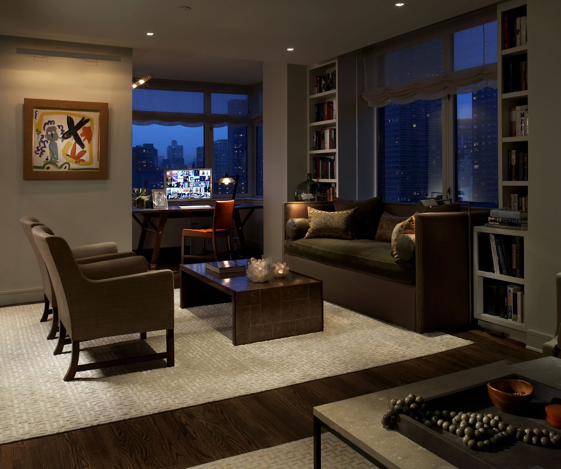 A living room with a couch and chairs and a desk