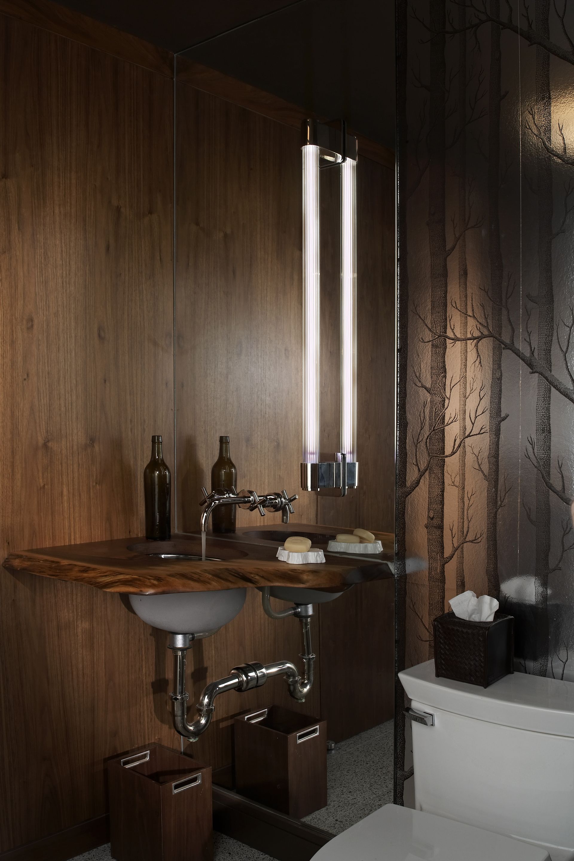 A bathroom with a sink , toilet and mirror.