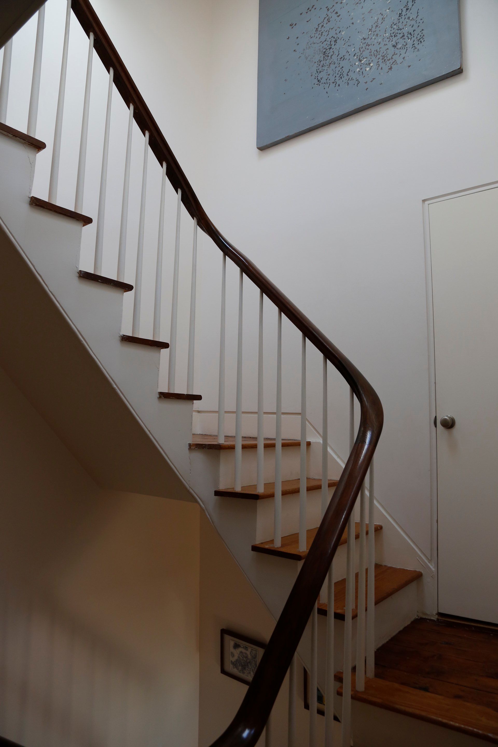 A staircase with white railings and wooden steps