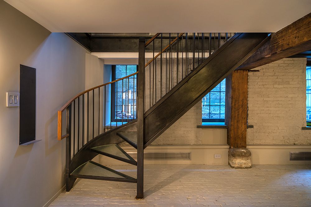 There is a spiral staircase in the middle of the room.