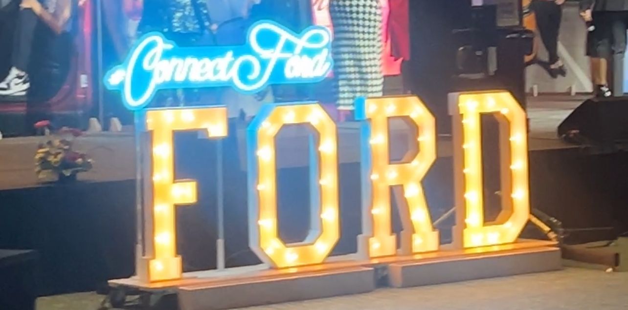 A large, glowing marquee sign spelling