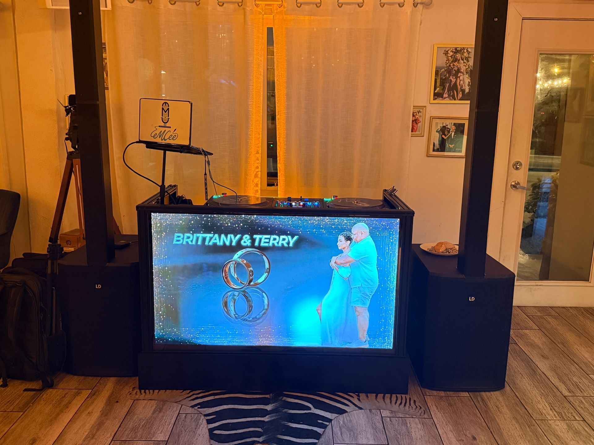 A DJ booth with a screen displaying