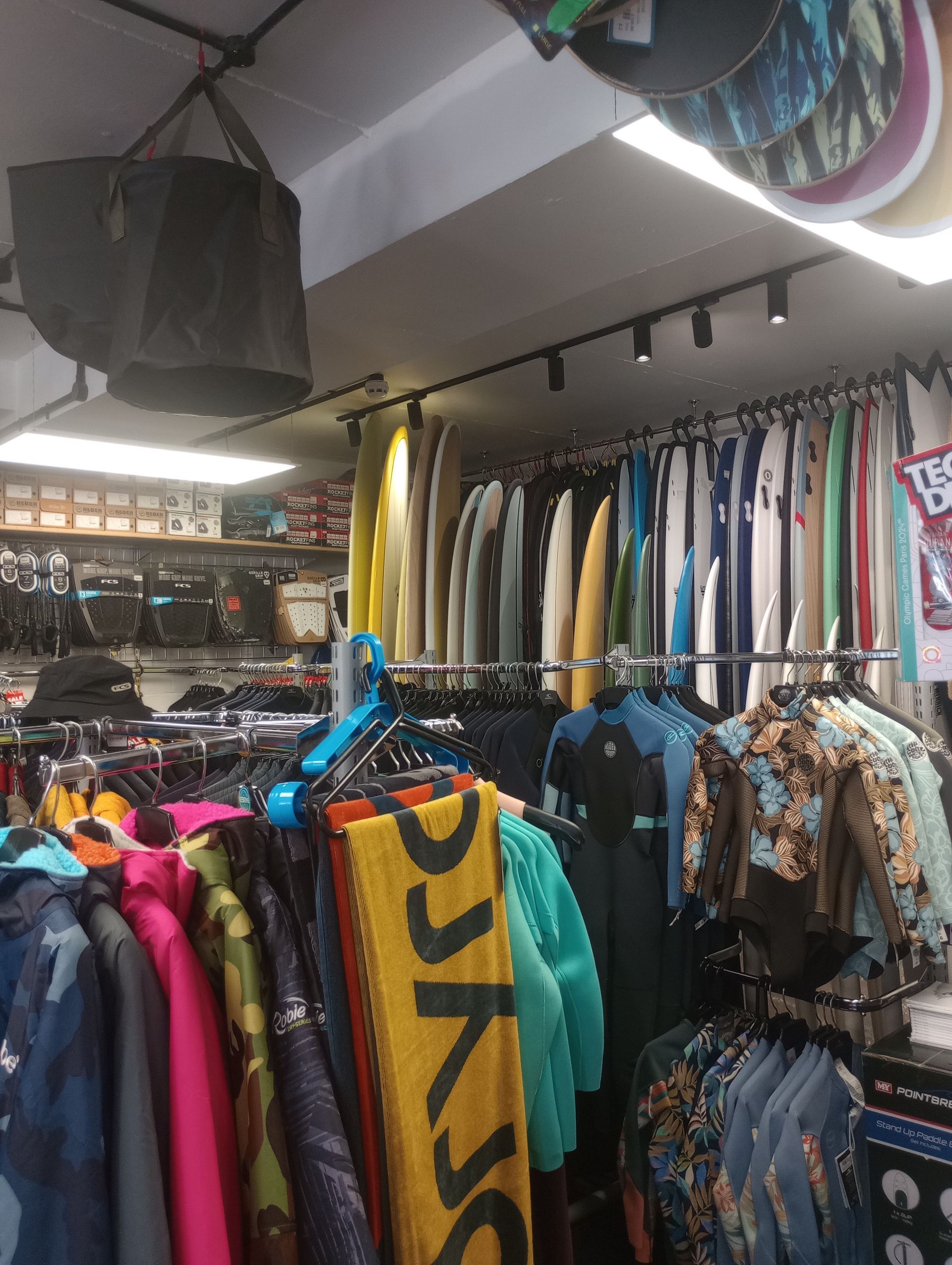 A store filled with lots of clothes and surfboards