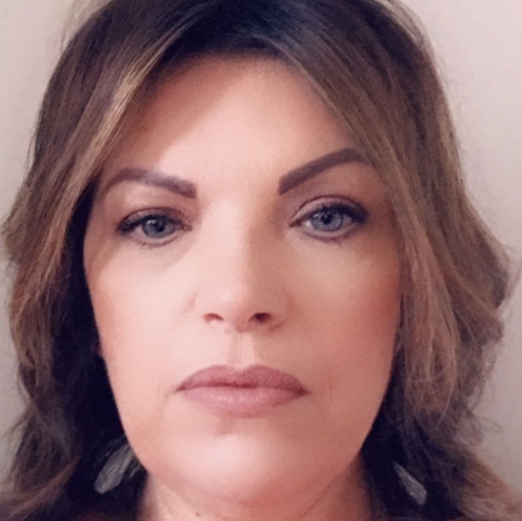 A close up of a woman 's face with a serious look on her face.