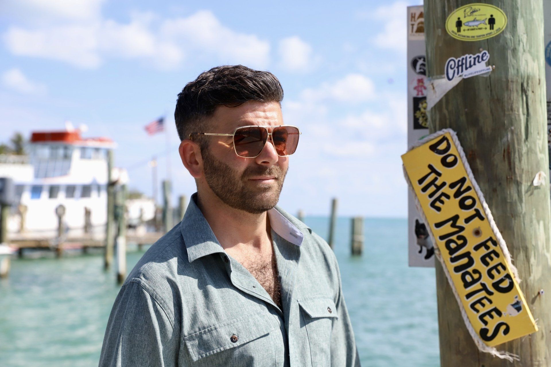 Man wearing sunglasses stands near a 