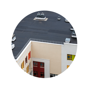 An aerial view of a building with a black roof