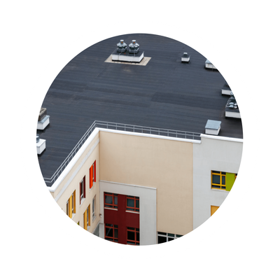 An aerial view of a building with a black roof