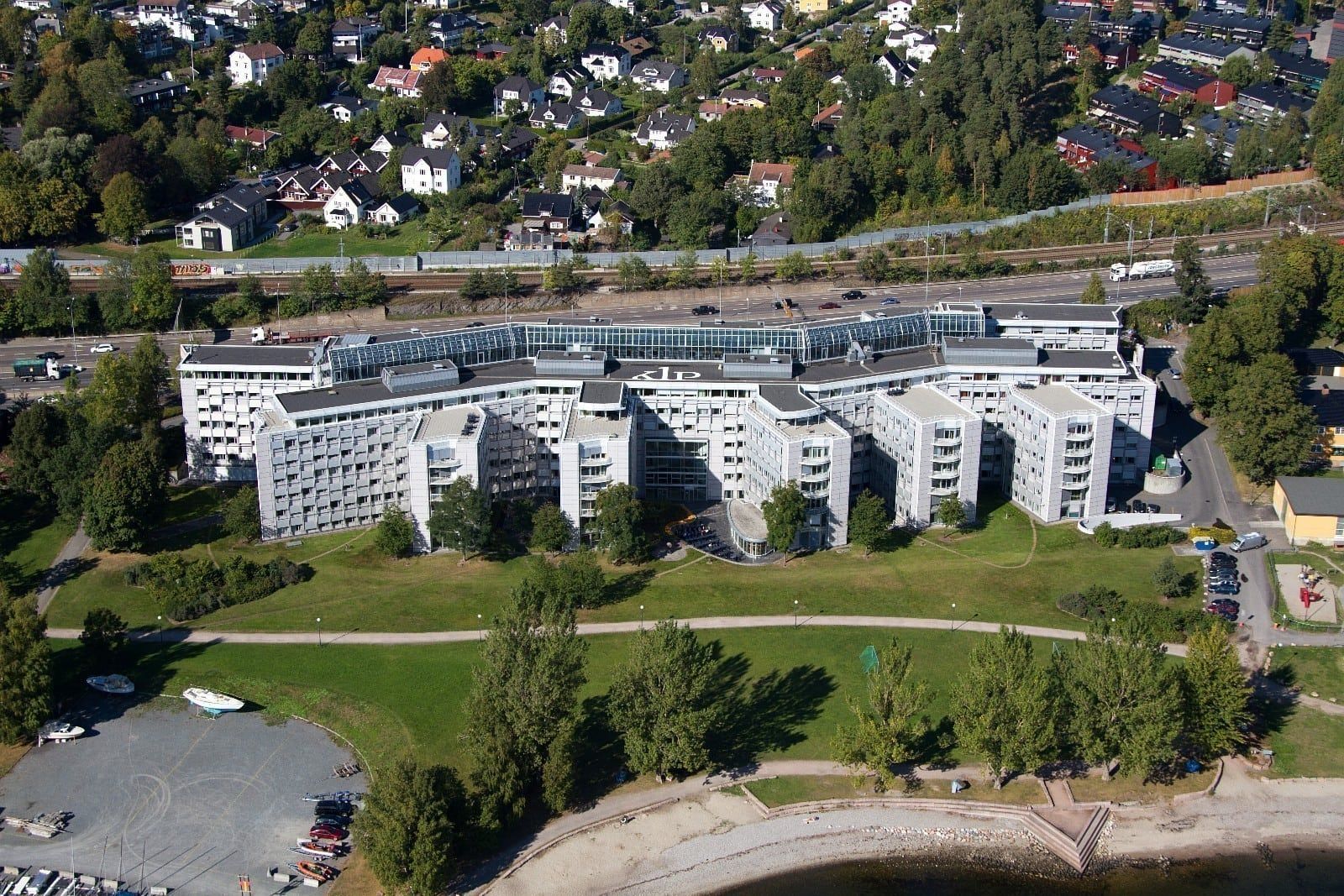 An aerial view of a city with a large building in the middle